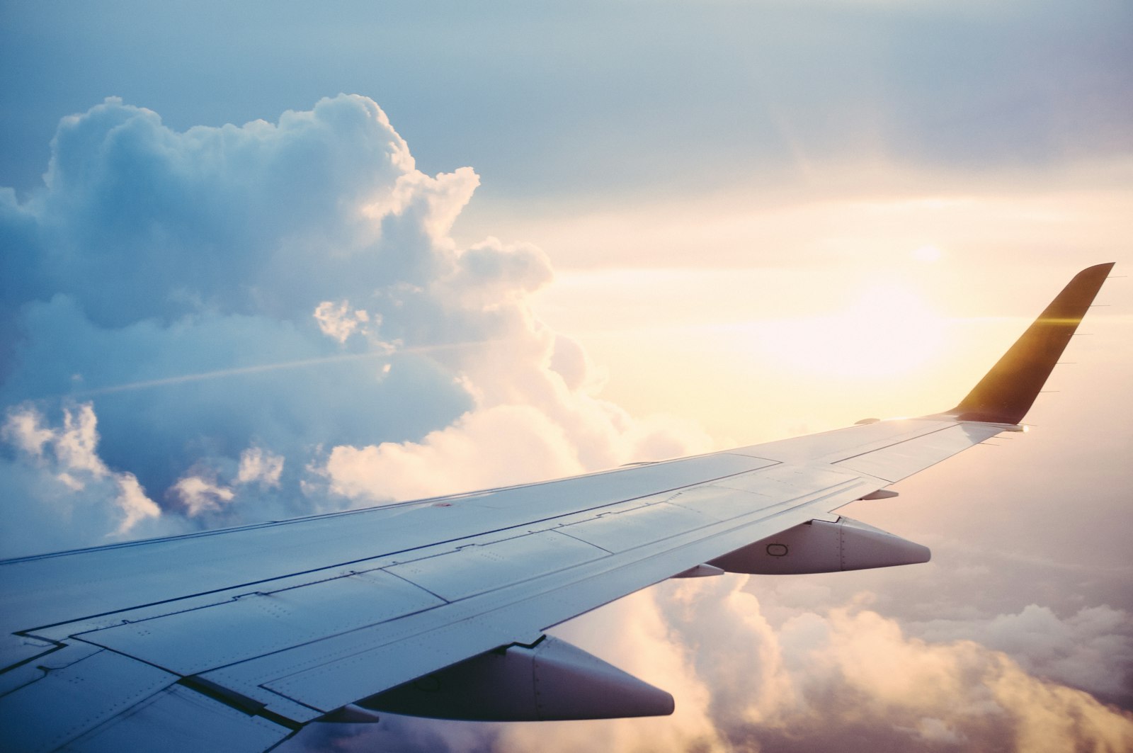 An airplane wing above the clouds